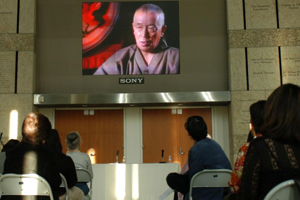 Audience members watch The Spirit of Taiko on a screen